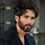 Shahid Kapoor height profile with a black outfit and indoor setting